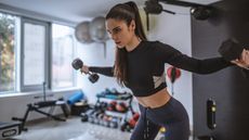Woman trains with dumbbells