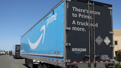 Amazon Prime logo is displayed on the side of an Amazon delivery truck 