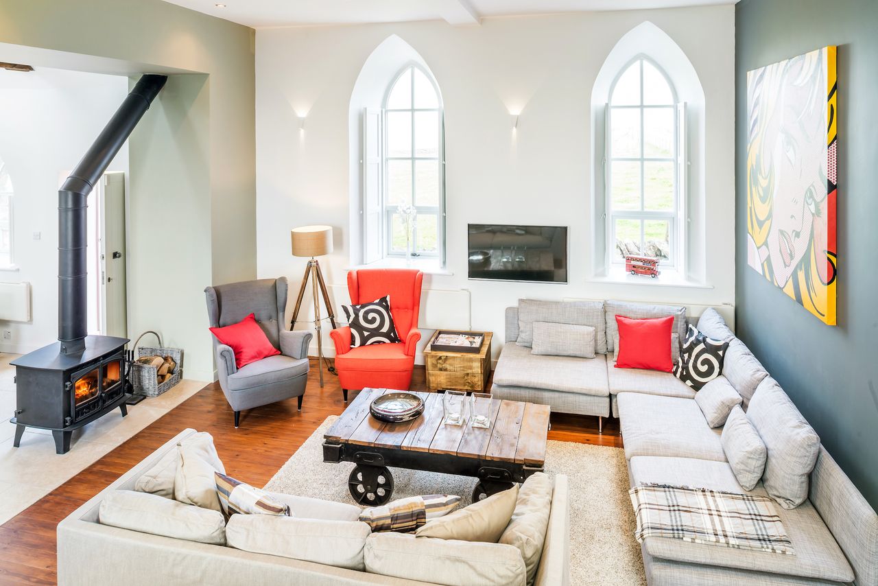 pale living room with woodburning stove and long windows
