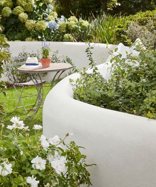 low curved garden wall painted cream