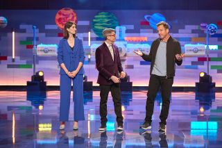 "Lego Masters" host Will Arnett (right) with Brickmasters Amy and Jamie in front of a Lego-built space station.