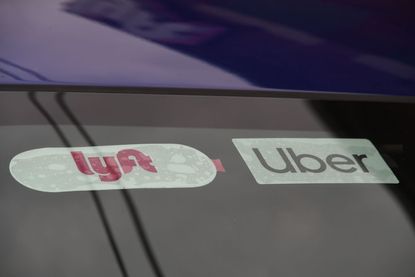 A car with Uber and Lyft stickers.