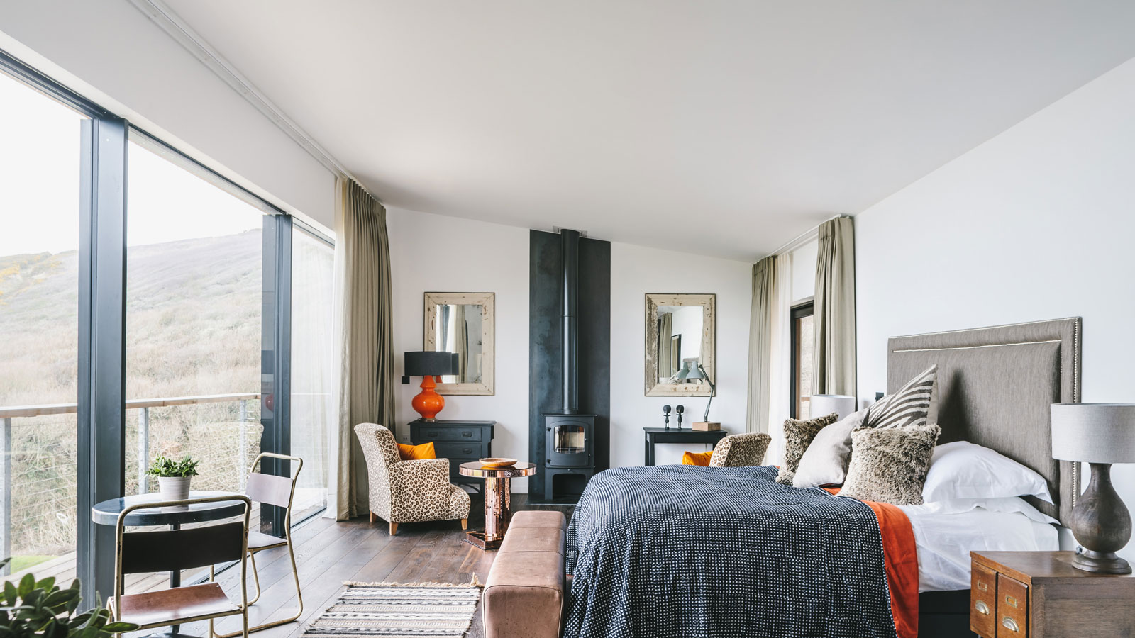 loft conversion bedroom with balcony and wood burning stove