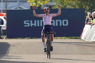 Dutch Guus Van de Eijnden celebrates as he crosses the finish line to win the men's junior race at the World Cup cyclocross in Maasmechelen