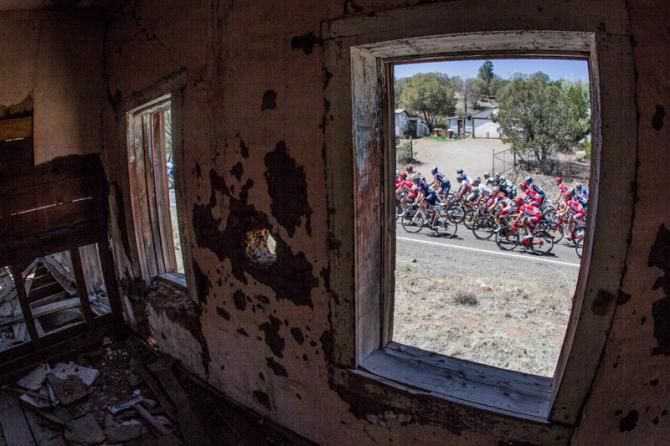 Riders pass by an old adobe house along today's route.
