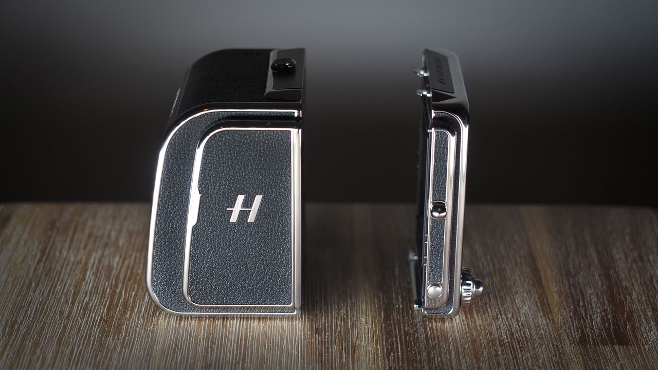 The Hasselblad 907X &amp; CFV 100C medium format camera with digital back, on a wooden table with artistic lighting