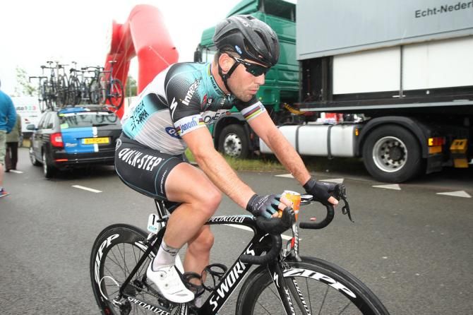 Third place finisher Mark Cavendish (Omega Pharma-QuickStep) heads to his team bus