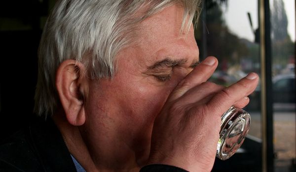 An older man drinking