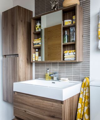 bathroom with wooden cabinets and washbasin