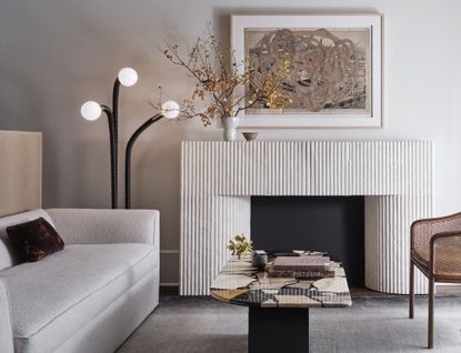 A white fireplace with a scalloped textural surface