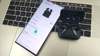 OnePlus Buds Pro with laptop and smartphone