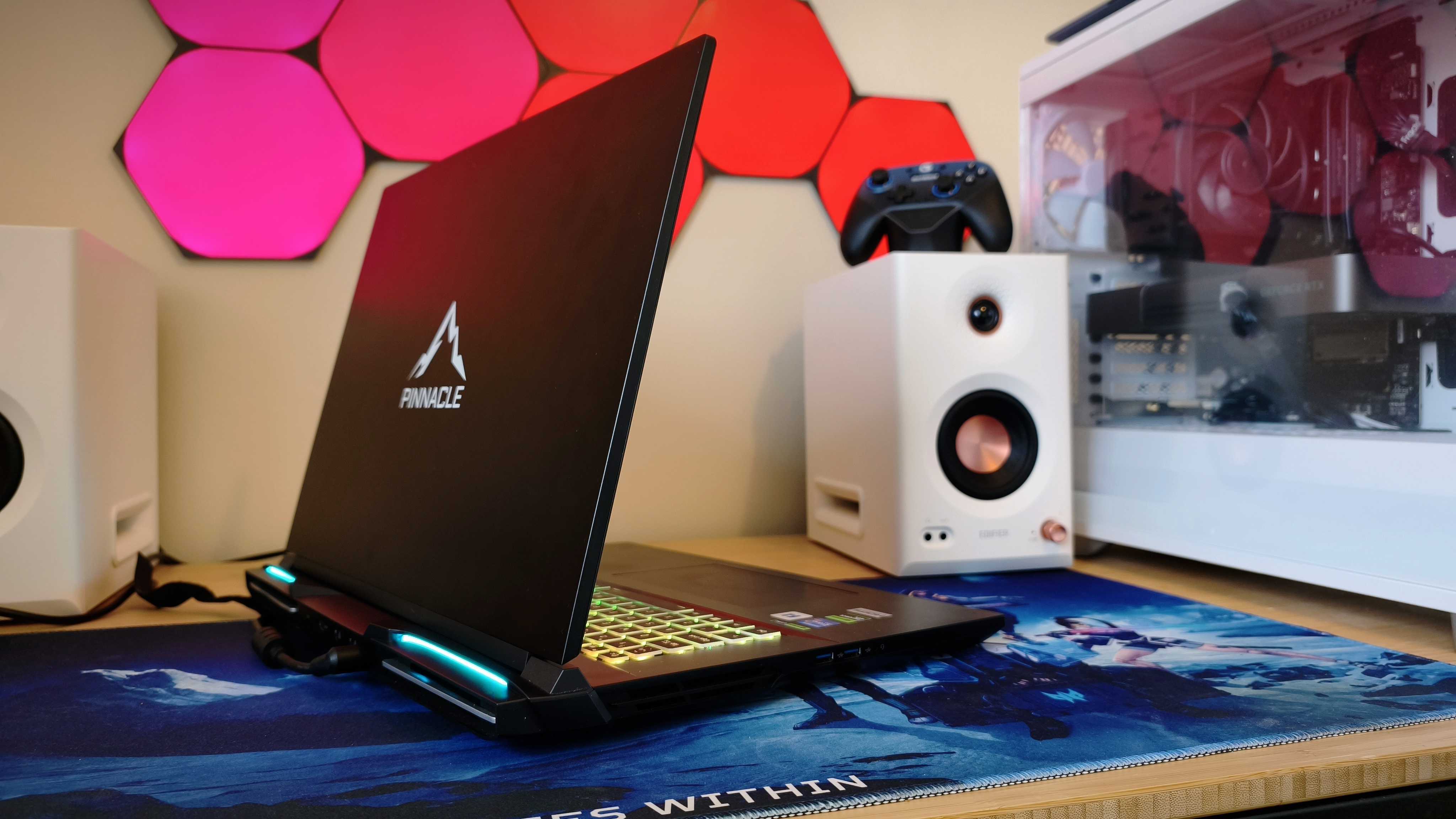 A black Overclockers Pinnacle laptop on a wooden desk