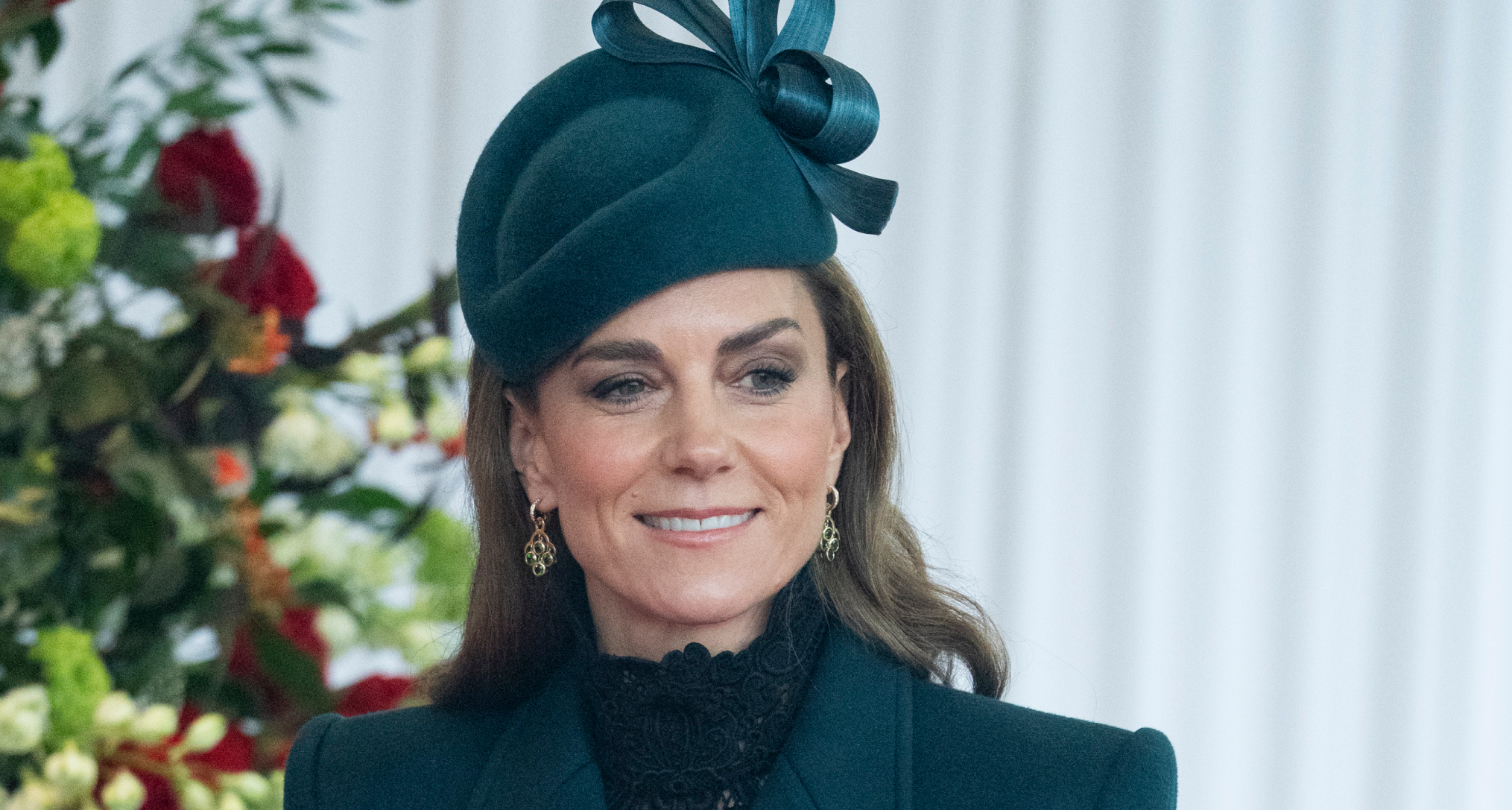 Princess Kate wearing a green hat and coat