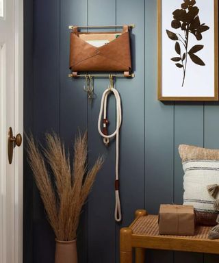 A blue hallway with a white door and wall accents