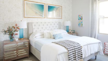 Finding out how to refresh a small bedroom is so useful. Here is a white bedroom with beachy wall art, a white bed, and a drawer with flowers on
