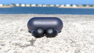 Hero image for best cheap wireless earbuds showing the Sony WF-C500 displayed on a concrete surface