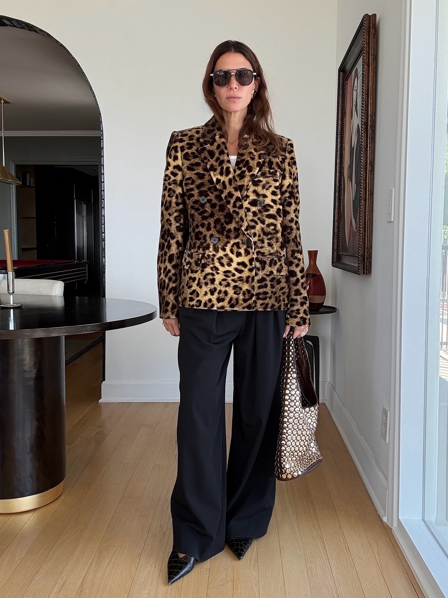 Influencer wearing a leopard blazer and black pants