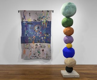 Precarious boulders are painted with vibrant hand-sourced pigments