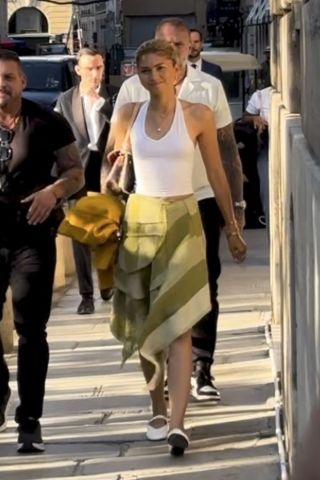 Zendaya wearing a white halter top with a green skirt and white Mary Jane ballet flats in Paris 2024 Olympics July 2024