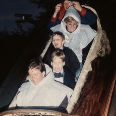 Princess Diana rides a log flume in an amusement park with sons Prince William and Prince Harry