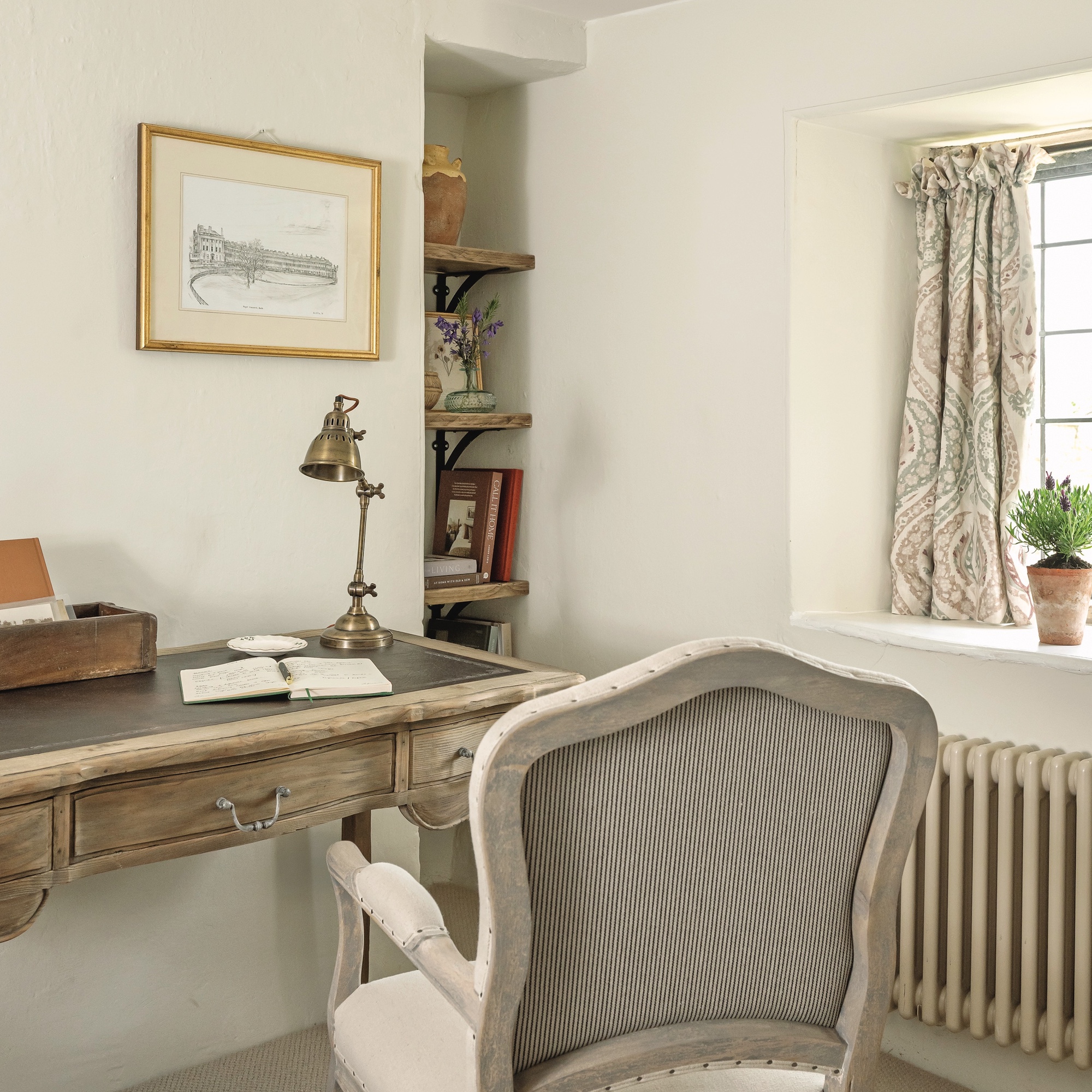 desk and chair in small cottage room painted white