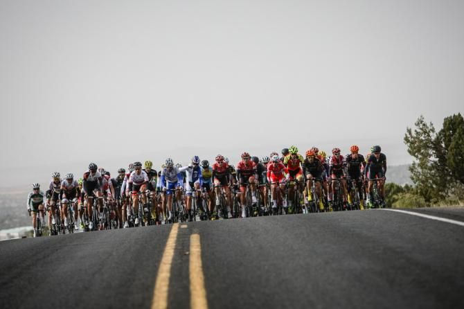 The mens field bunches up on the first climb of the day