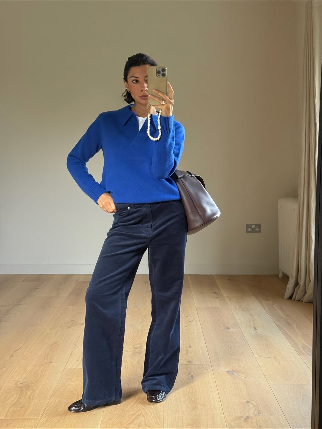 Marianne wearing cobalt blue polo knit