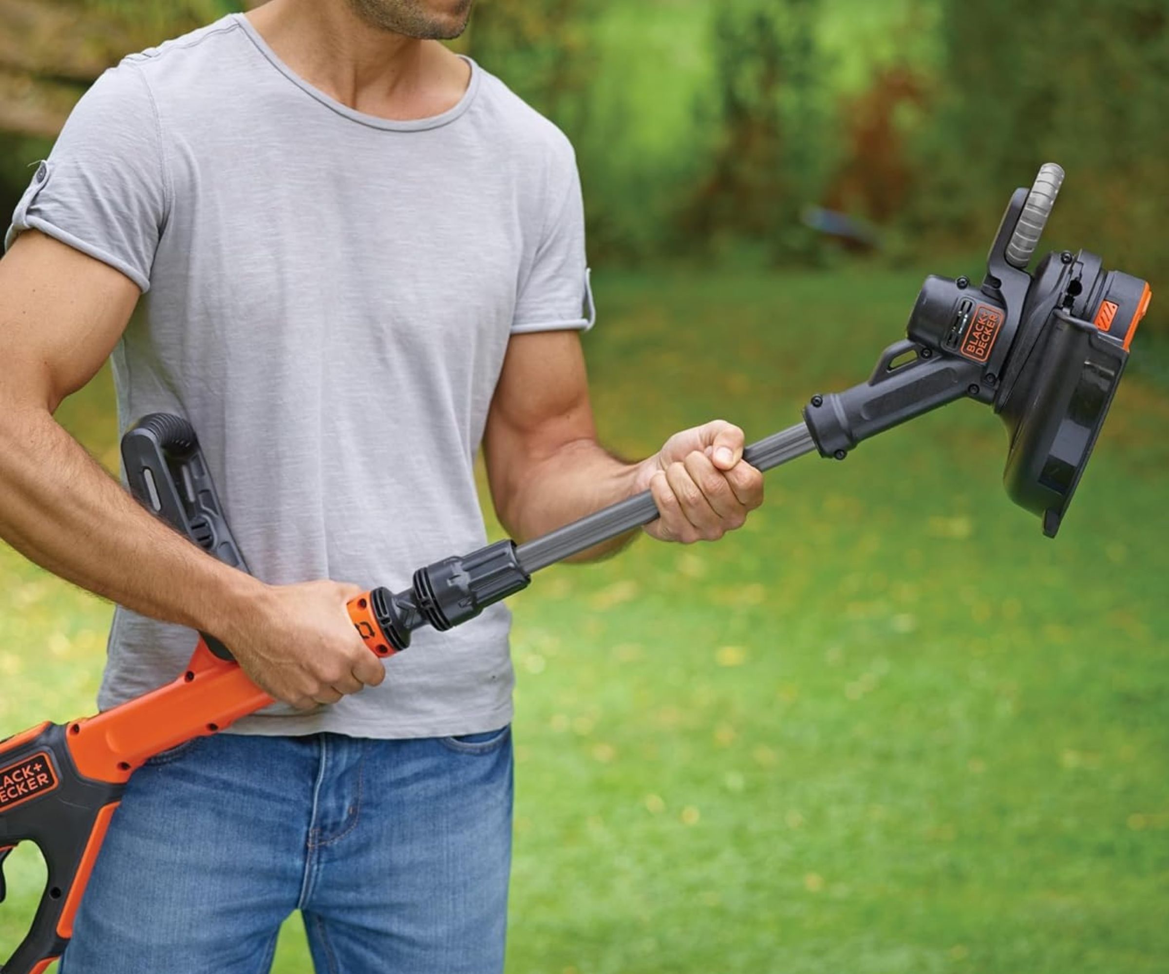 BLACK+DECKER POWERCONNECT Strimmer being held by a man