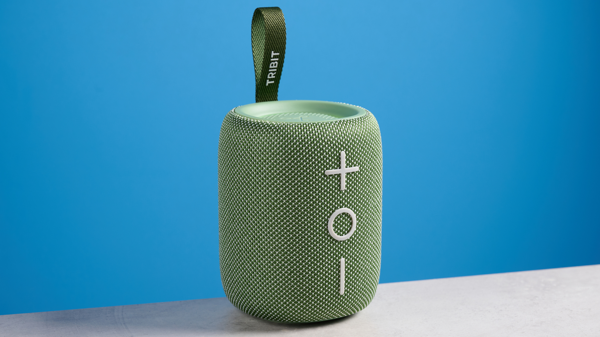 A green Tribit StormBox Mini+ speaker