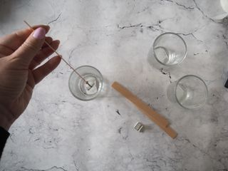Adding wooden wicks to homemade candles