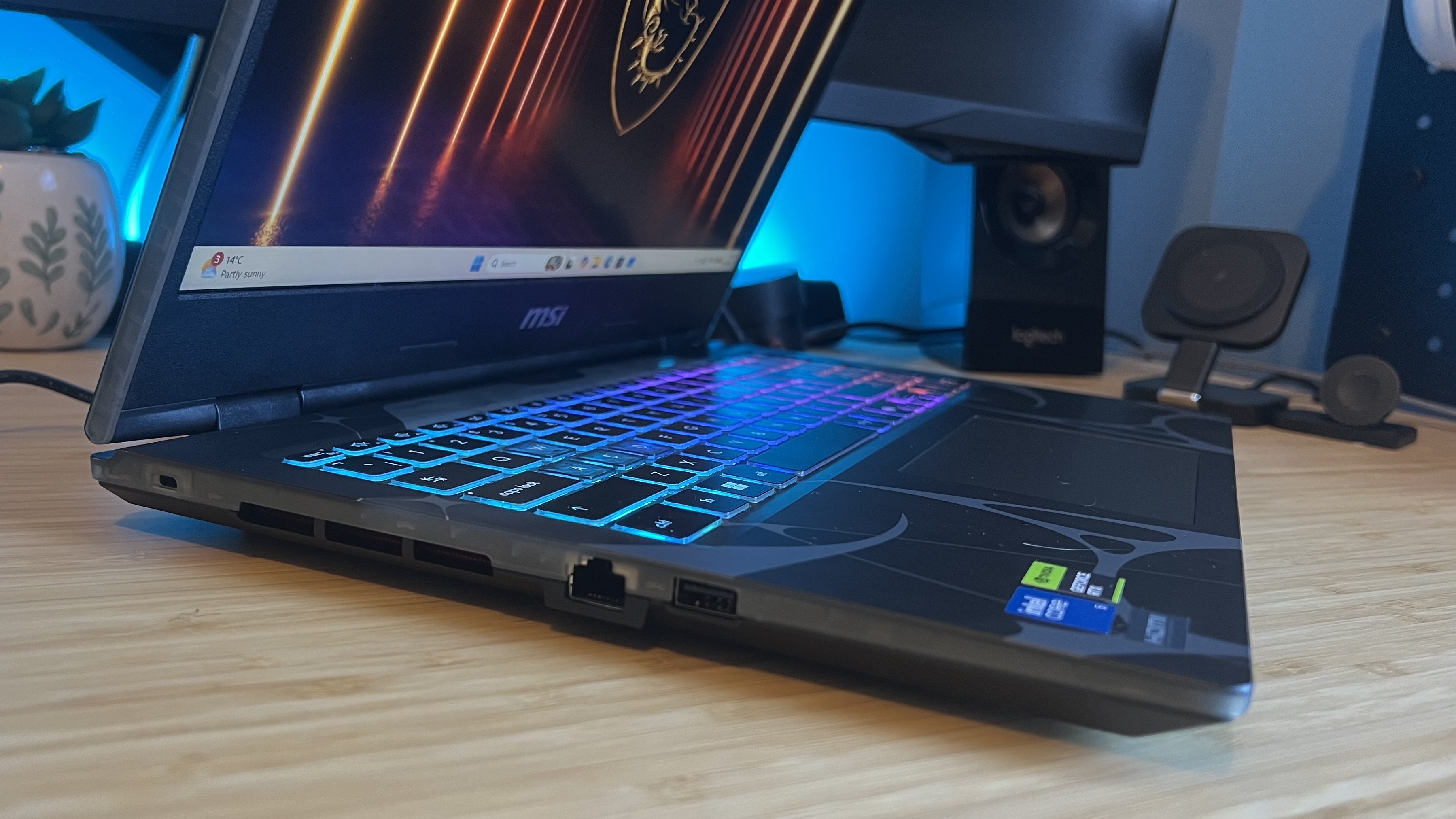 Side view of MSI Cyborg gaming laptop on a wooden desk