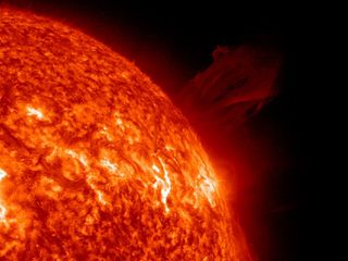 This image from the SOHO spacecraft shows a huge coronal mass ejection erupt from the sun's surface shortly before a comet dove towards the sun and disappeared. The solar explosion occurred before the comet was close enough to have any impact, NASA officials say.