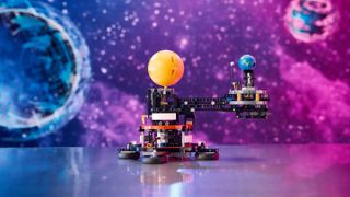 The Lego Technic Planet Earth and Moon in Orbit set photographed in front of a starry background.