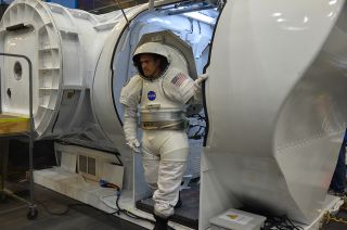 David Coan, wearing a Mark III spacesuit, exits NASA’s multi-mission Space Exploration Vehicle (SEV) during an asteroid mission simulation at the Johnson Space Center in Houston, Aug. 30, 2012.