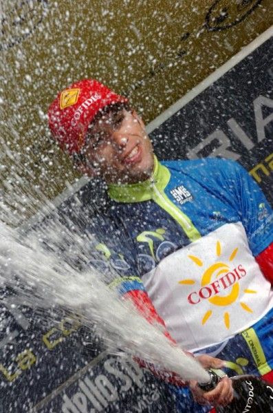 Race leader Julien El Far&egrave;s (Cofidis) uncorks the bubbly on the podium.