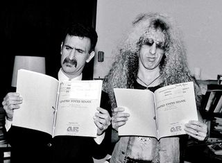 Dee Snider and Frank Zappa looking at legal papers