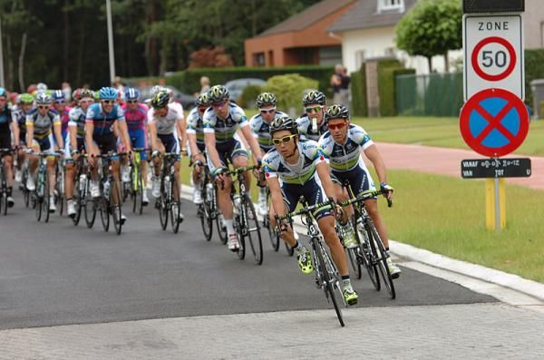 Orica-GreenEdge sets tempo in the peloton with Fumiyuki Beppu on the front.