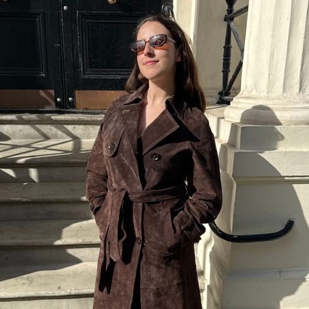 An image of Who What Wear UK fashion writer, Ava Gilchrist, wearing one of the best suede trench coats. 