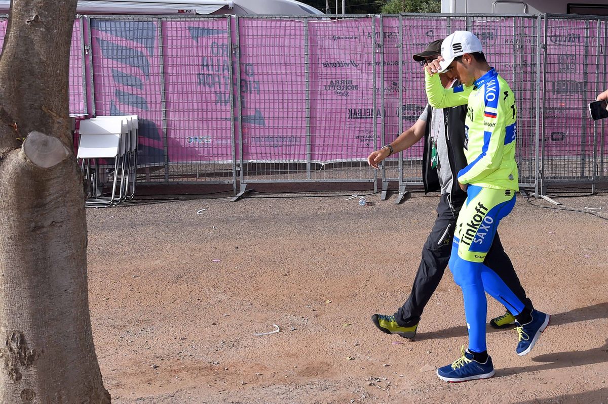Alberto Contador walks to see the doctor after his late stage crash