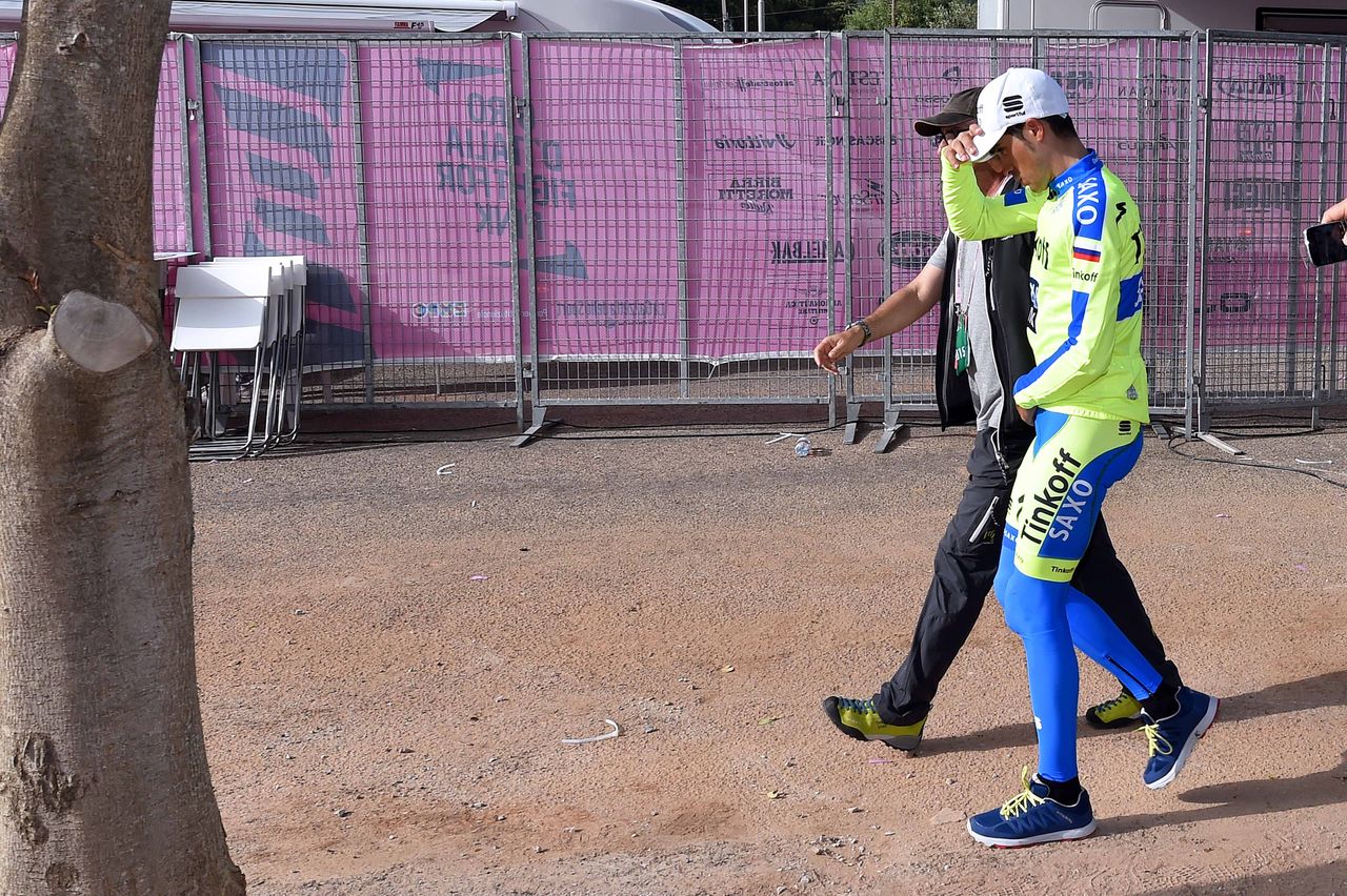 Alberto Contador walks to see the doctor after his late stage crash
