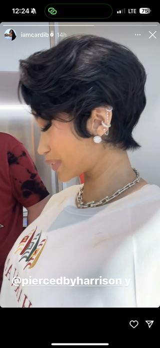 cardi b takes a photo with a tousled pixie cut and three new piercings