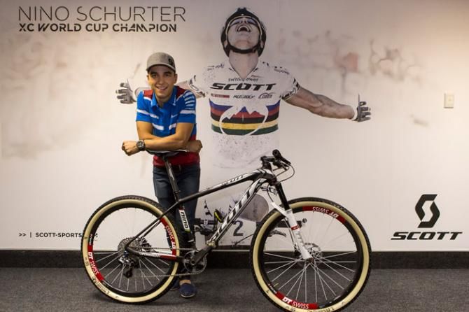 Nino Schurter poses in front of a massive poster of him at Jowett's Cycles, Pietermaritzburg, South Africa. Schurter will attempt to successfully defend his Elite men's cross country World Championship title on Saturday.
