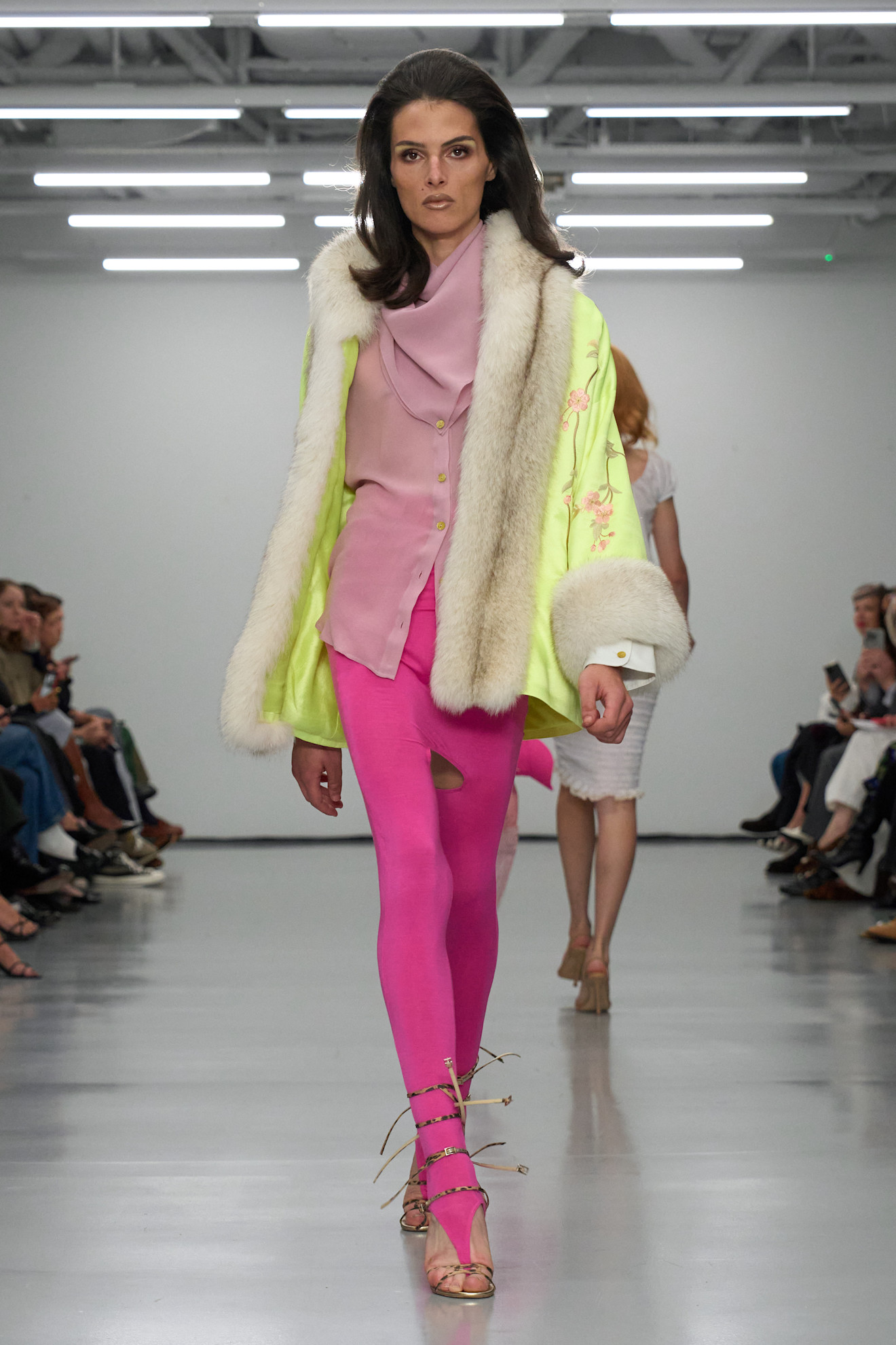 A model wore hot pink stirrup leggings on the Conner Ives Spring 2026 runway