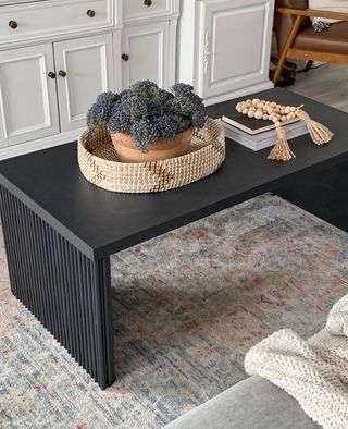 Black coffee table on antique style rug