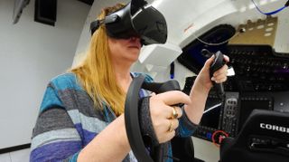 Boeing software engineer Connie Miller tries out a Varjo virtual reality headset, which astronauts that ride on Boeing's Starliner capsule will use to train for their missions.