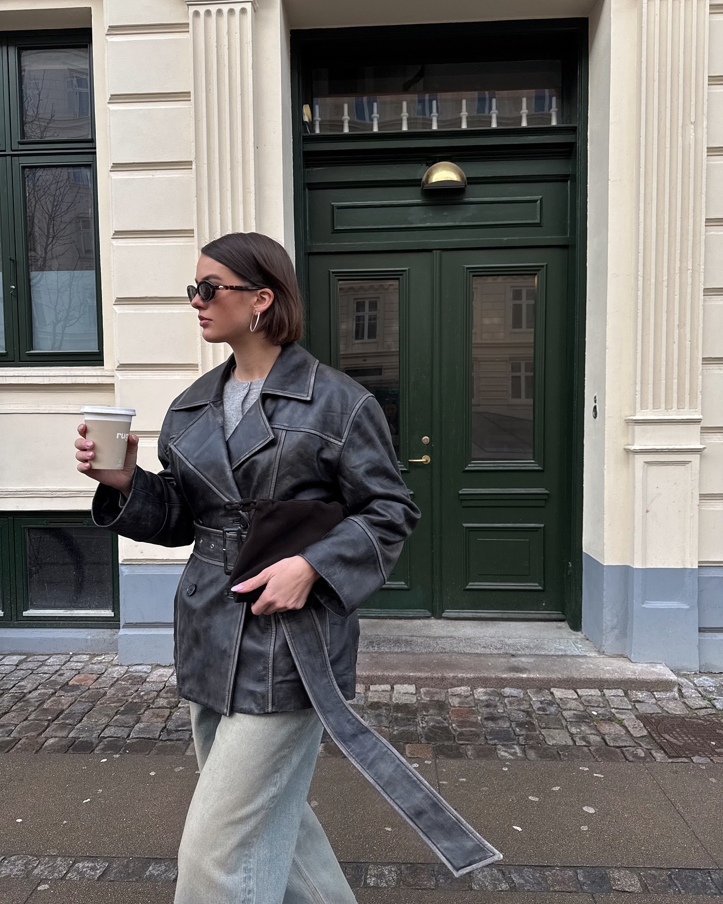Mary L. Jean wearing an oversized trench coat and gay jeans in Copenhagen