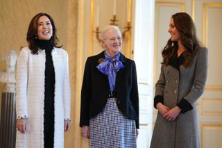 Catherine, Duchess of Cambridge (R) is welcomed by Queen Margrethe II (C) and Crown Princess Mary of Denmark (L) during an audience at Christian IX's Palace