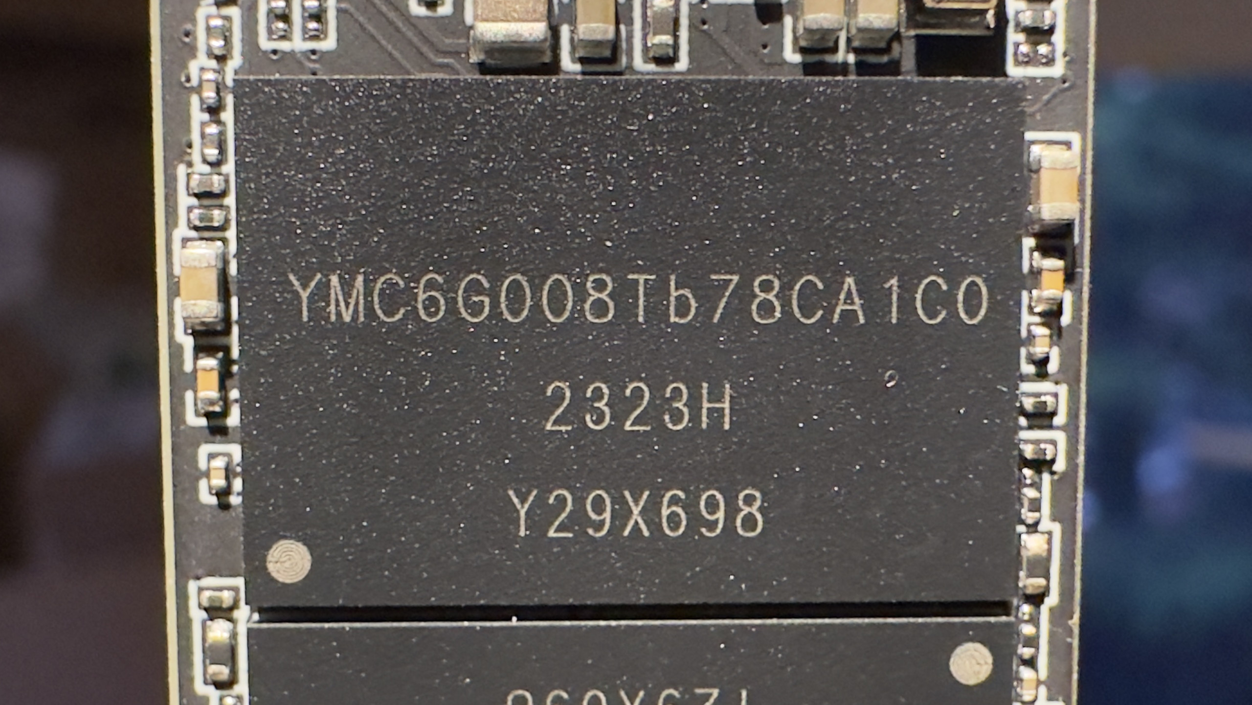 A close-up photo of a YMTC 232-layer TLC 3D-NAND flash memory module, from a Team Group MP44 SSD