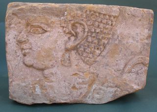 ancient relief with carving of princess 