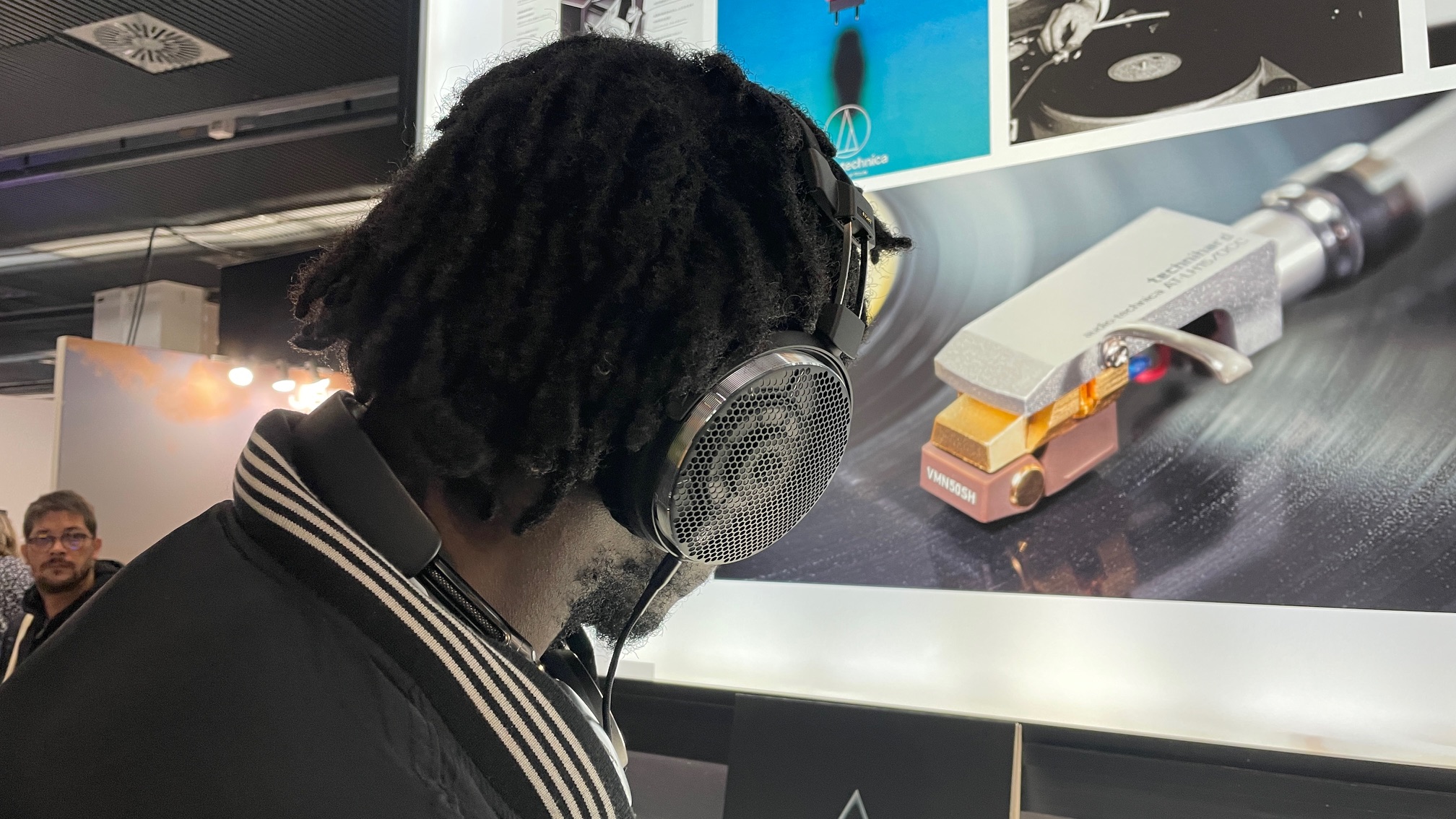 A selection of headphones, including the Audio-Technica ATH-ADX7000 worn by a man in Paris